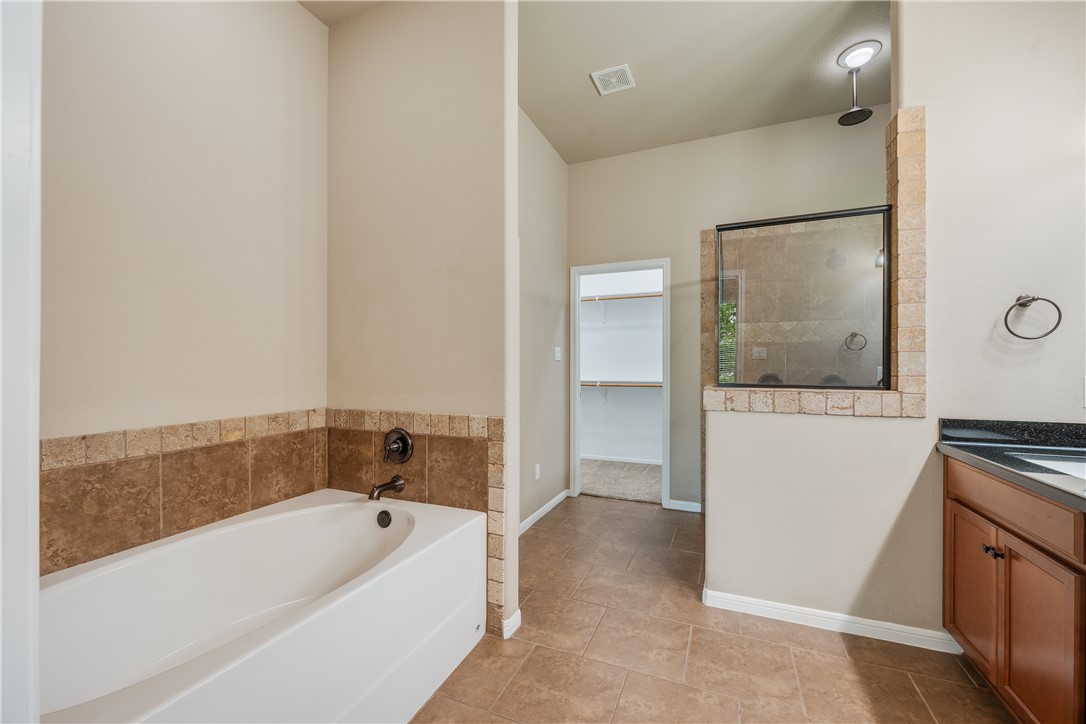 3085 Archer Circle Bryan, TX 77808 - Photo 12 of 31 a bathroom with a bathtub and a sink