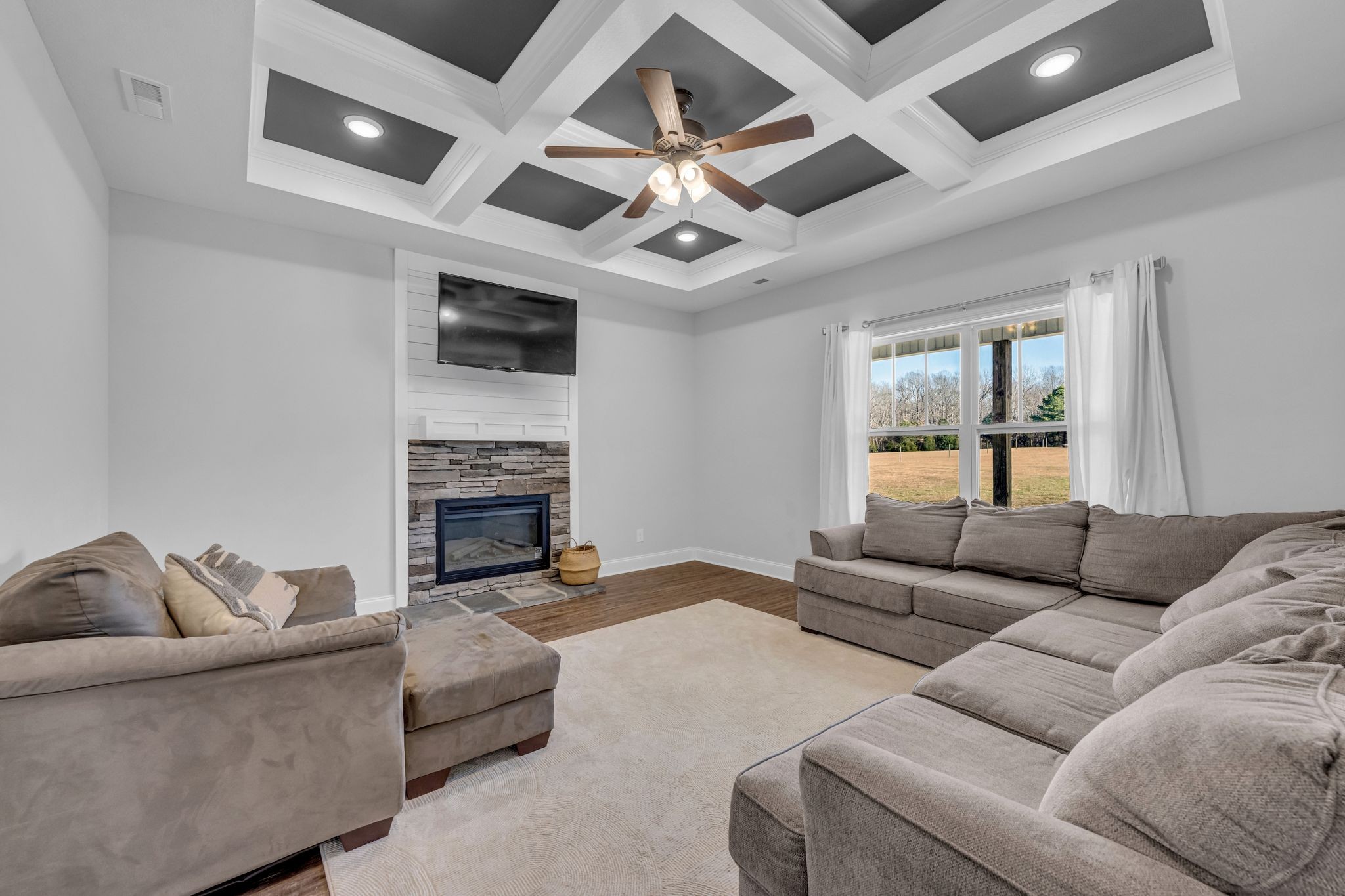1277 Lecomte Road Dickson, TN 37055 - Photo 6 of 30 a living room with furniture a fireplace and a flat screen tv