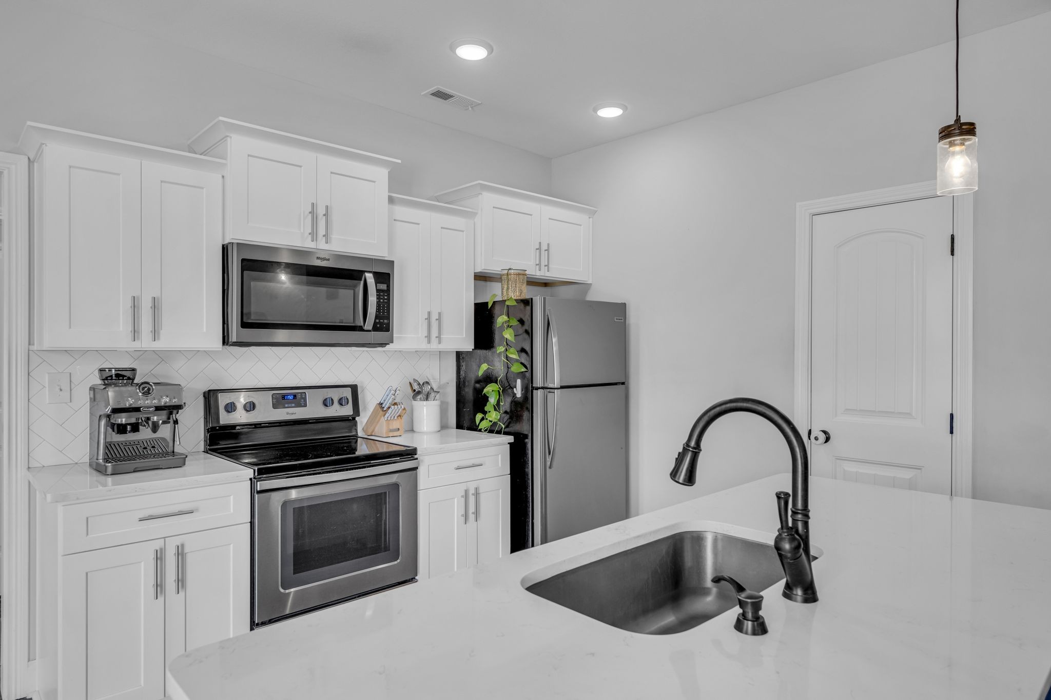 1277 Lecomte Road Dickson, TN 37055 - Photo 8 of 30 a kitchen with stainless steel appliances kitchen island a refrigerator sink and white cabinets