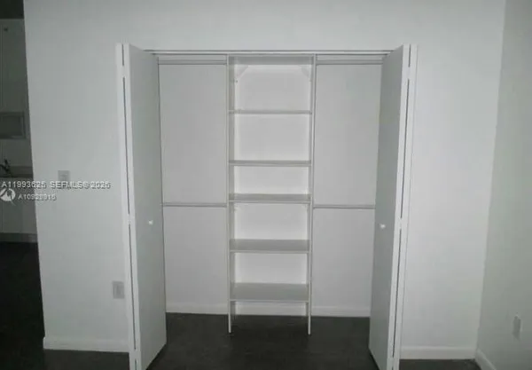 a view of an empty room with a window