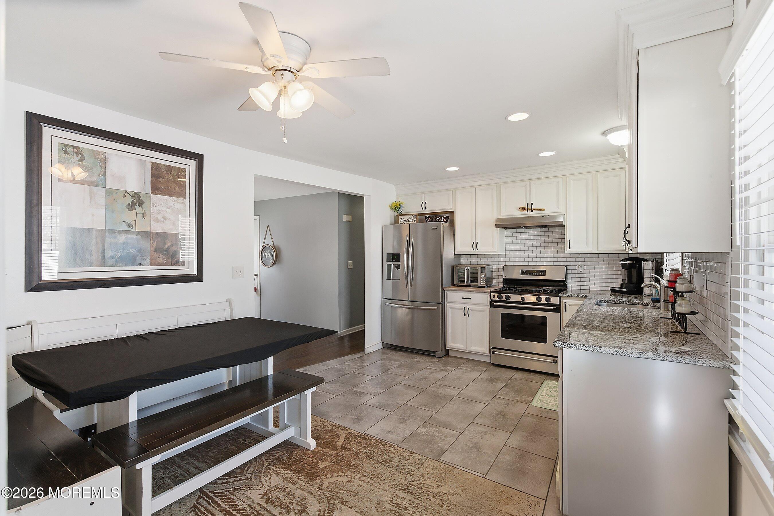 7 Letts Landing Road Waretown, NJ 08758 - Photo 11 of 18 a kitchen with stainless steel appliances kitchen island granite countertop a stove a sink and a refrigerator