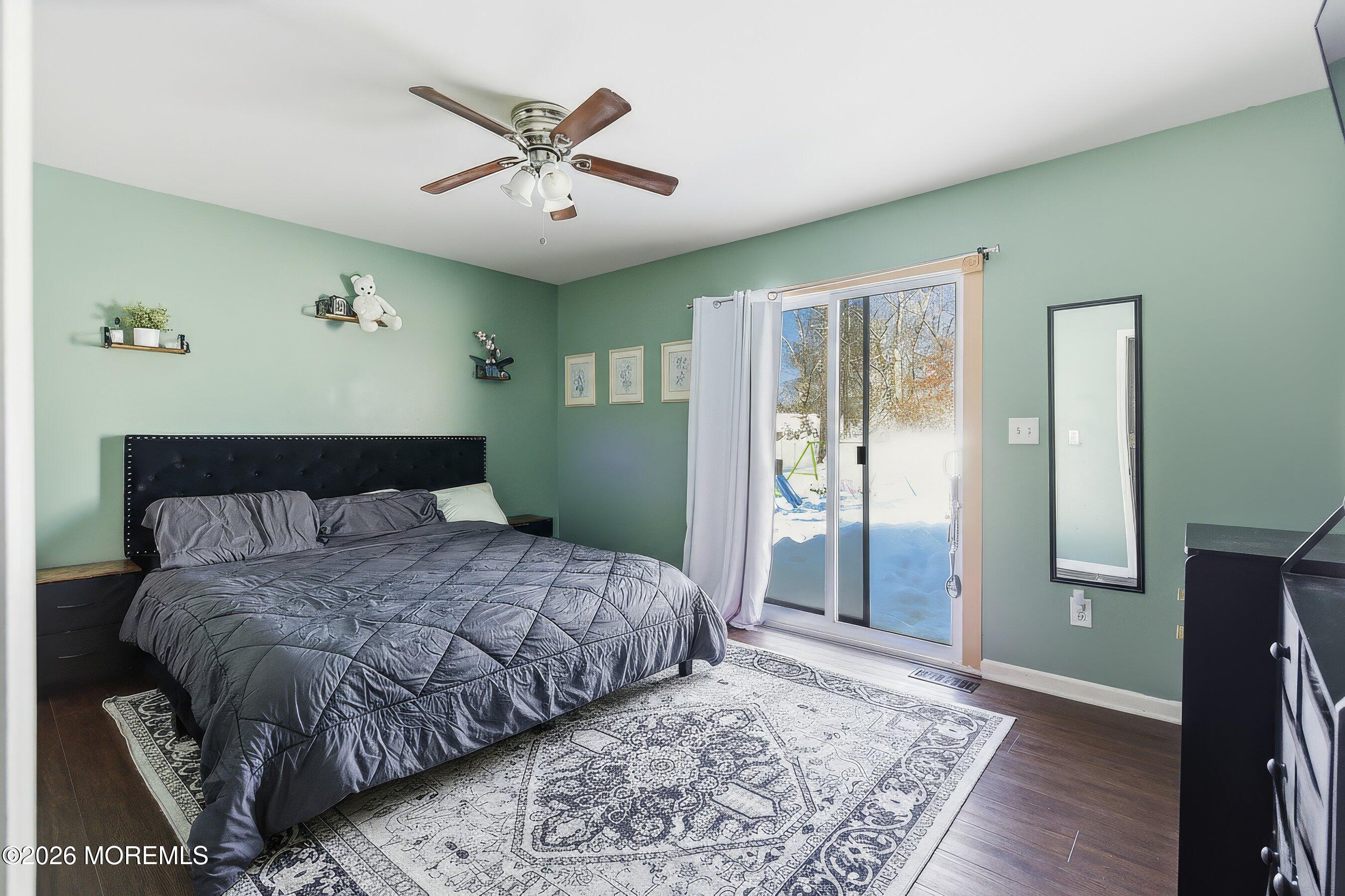 7 Letts Landing Road Waretown, NJ 08758 - Photo 13 of 18 a bedroom with a large bed and a chandelier