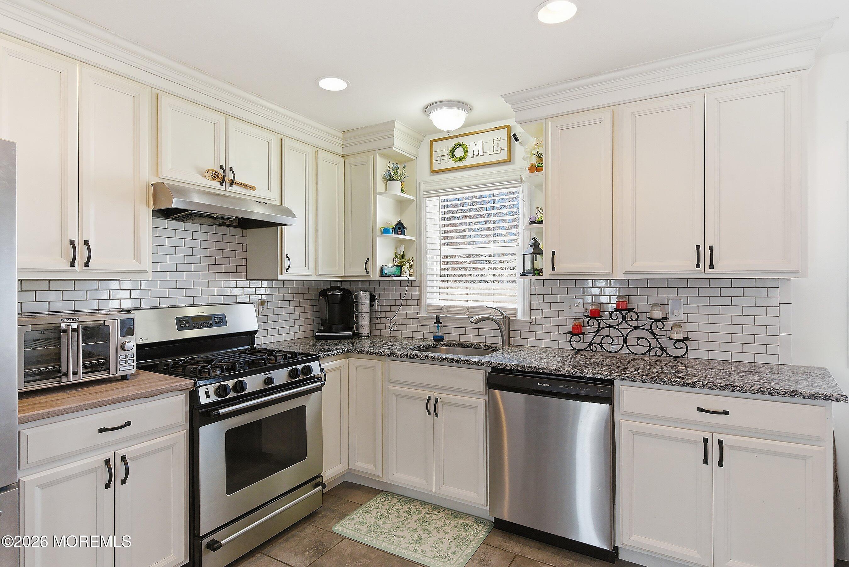 7 Letts Landing Road Waretown, NJ 08758 - Photo 8 of 18 a kitchen with white cabinets and appliances