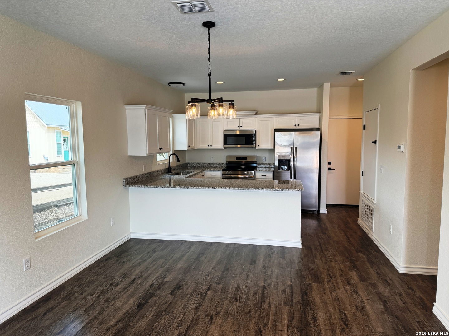600 A 10th Bandera, TX 78003 - Photo 4 of 13 a kitchen with stainless steel appliances a refrigerator sink and microwave