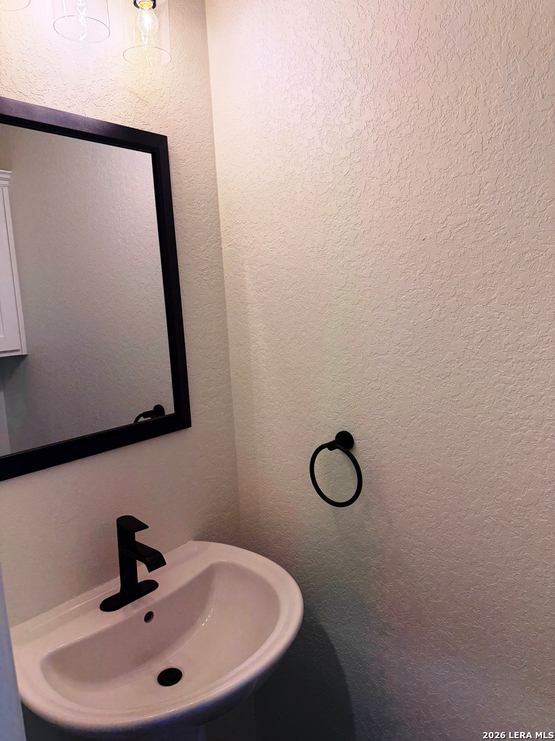 600 A 10th Bandera, TX 78003 - Photo 7 of 13 a bathroom with a sink and mirror