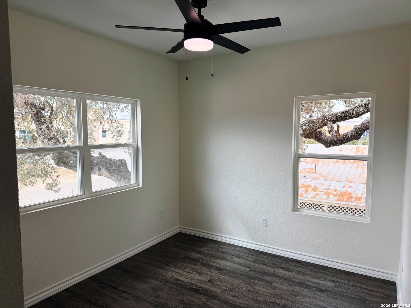 600 A 10th Bandera, TX 78003 - Photo 8 of 13 a view of an empty room with wooden floor and a window