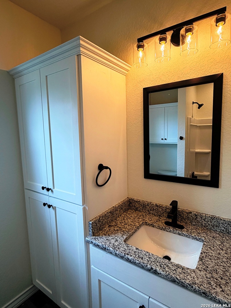 600 A 10th Bandera, TX 78003 - Photo 10 of 13 a bathroom with a sink and a mirror