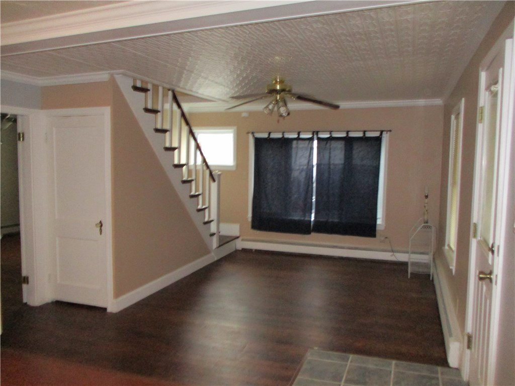 Living room w/ hardwood and tin ceiling
