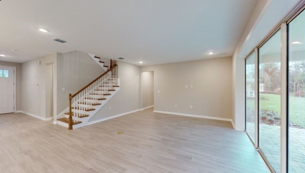86504 Oar Row North Yulee, FL 32097 - Photo 11 of 28 an empty room with wooden floor and windows