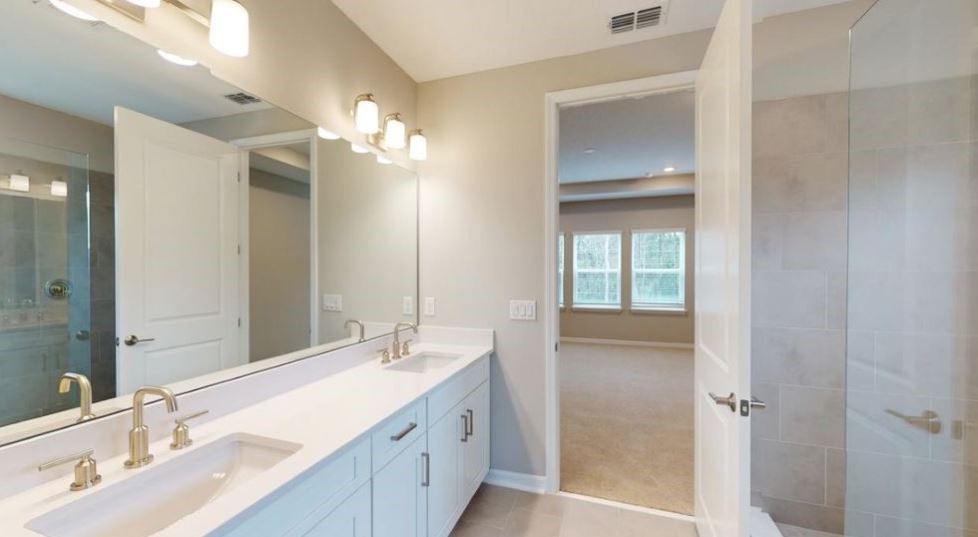 86504 Oar Row North Yulee, FL 32097 - Photo 12 of 28 a bathroom with a double vanity sink and a mirror