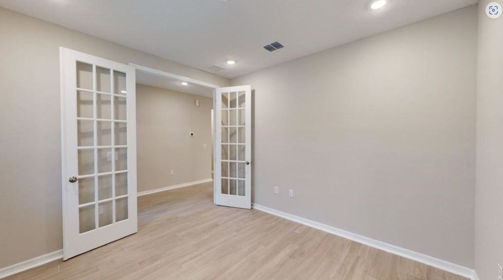86504 Oar Row North Yulee, FL 32097 - Photo 19 of 28 an empty room with wooden floor and windows