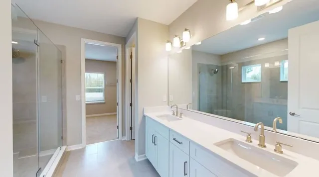 a bathroom with a double vanity sink and a mirror