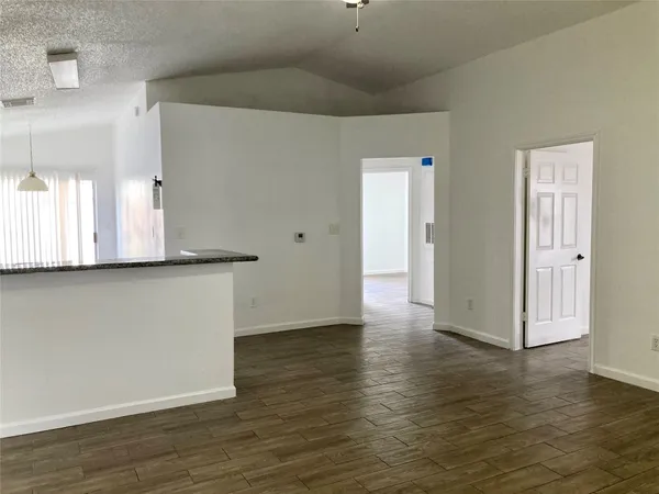 a view of a room with wooden floor and a large window
