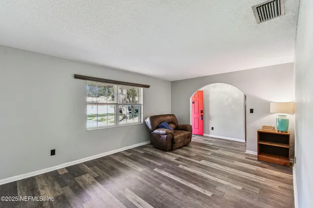 a view of a dining room with furniture and wooden floor