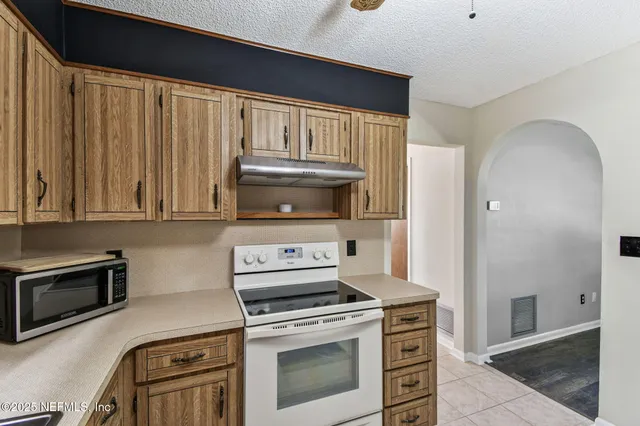 a kitchen with a refrigerator and a sink