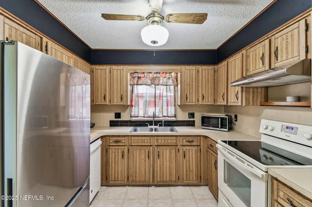 a kitchen with a stove a sink and a microwave