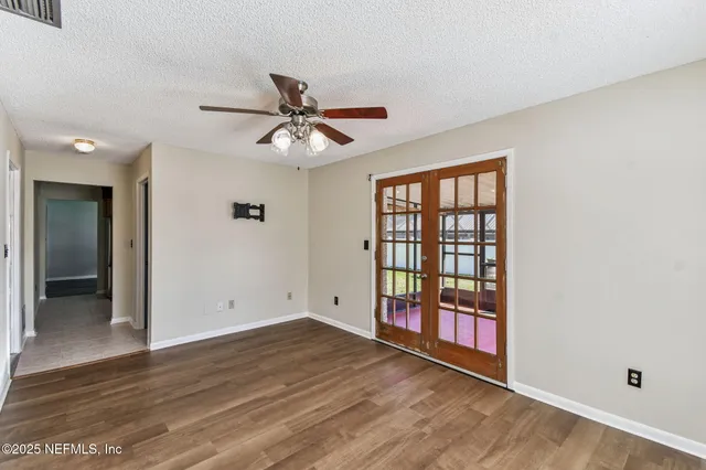 a view of room with hardwood floor and ceiling fan