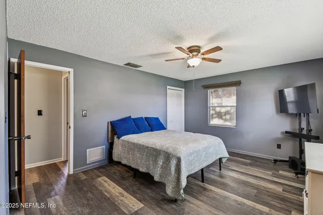 a view of a workspace with furniture and wooden floor