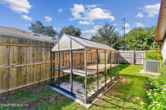 an aerial view of a house with yard swimming pool and outdoor seating
