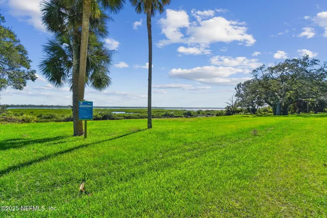 an aerial view of a house with a swimming pool yard and outdoor seating