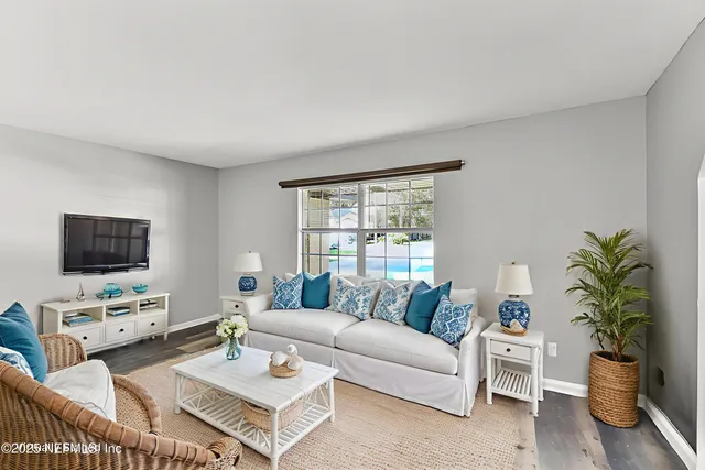 a living room with furniture and a kitchen area