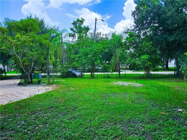 a view of grassy field with benches