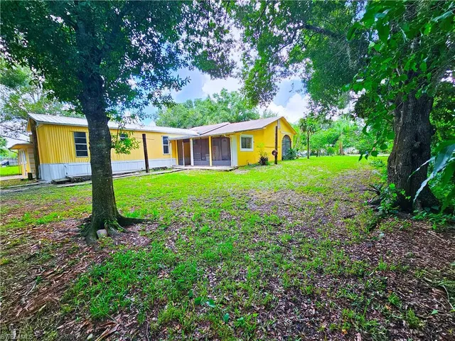a view of a house with yard and a garden