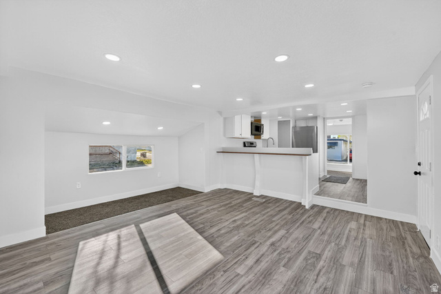 2491 Highway 89, Unit 523 Pleasant View, UT 84404 - Photo 7 of 31 Unfurnished living room with dark wood-type flooring and recessed lighting