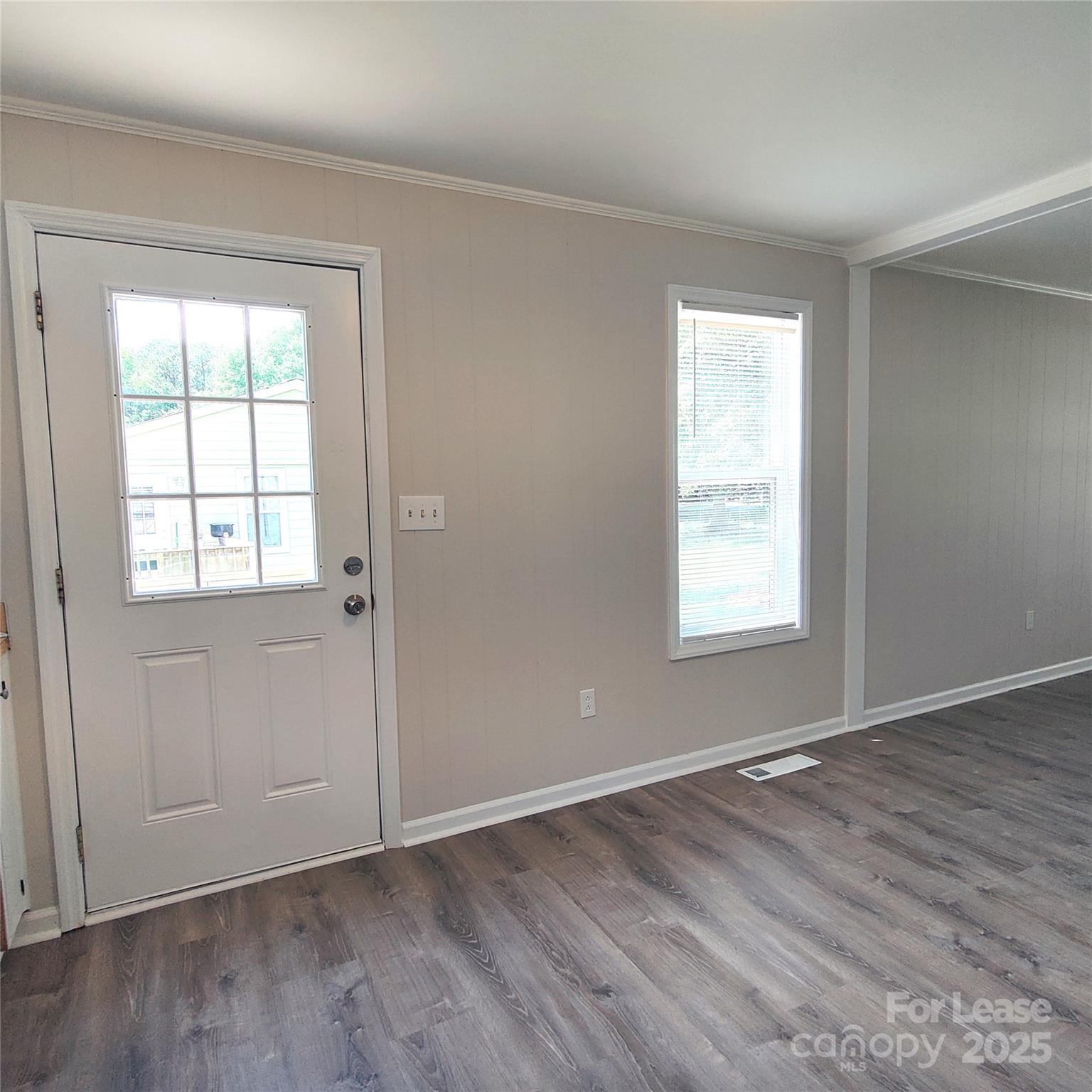 5325 Hemby Road, Unit B Weddington, NC 28104 - Photo 12 of 19 an empty room with wooden floor and windows