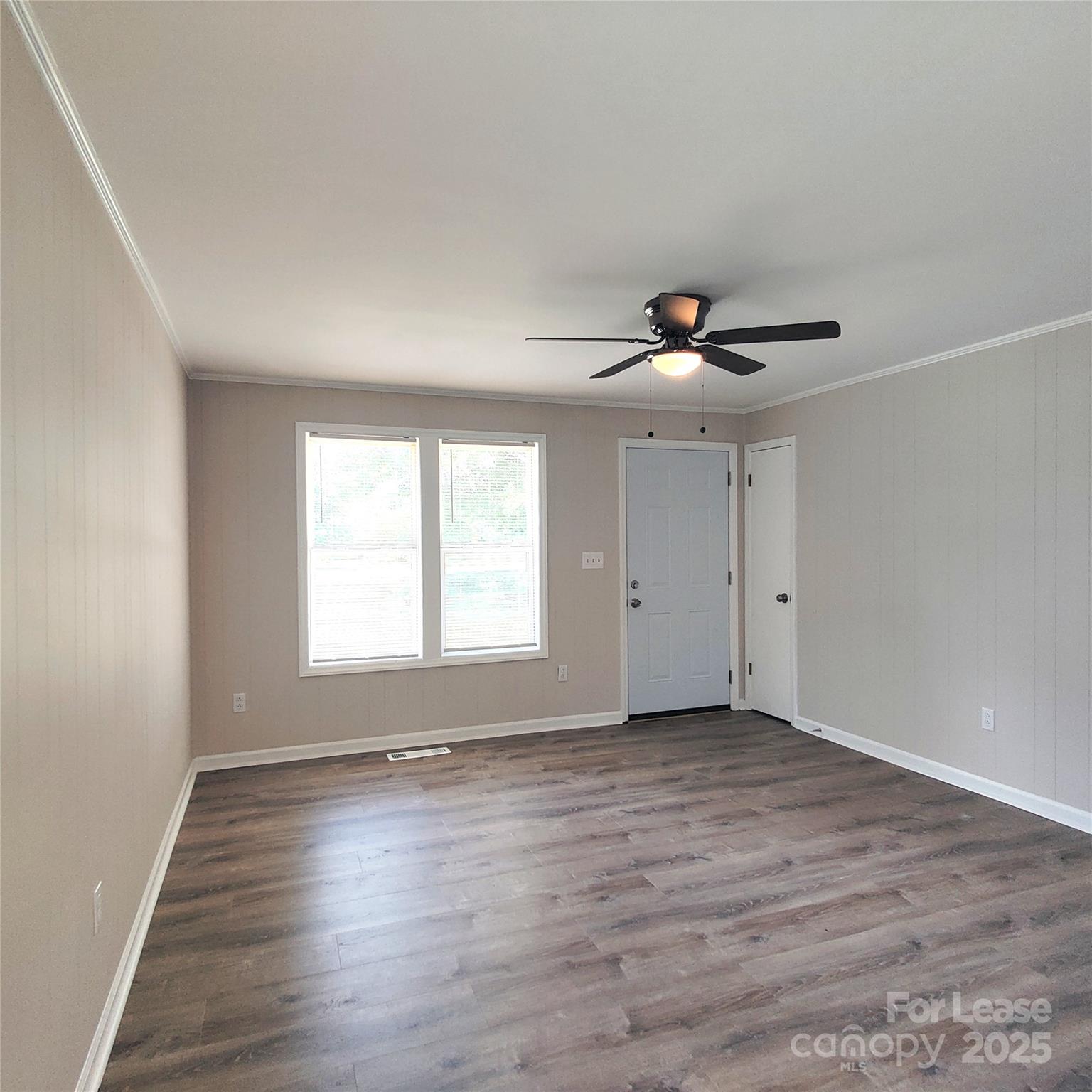 5325 Hemby Road, Unit B Weddington, NC 28104 - Photo 7 of 19 an empty room with wooden floor and windows