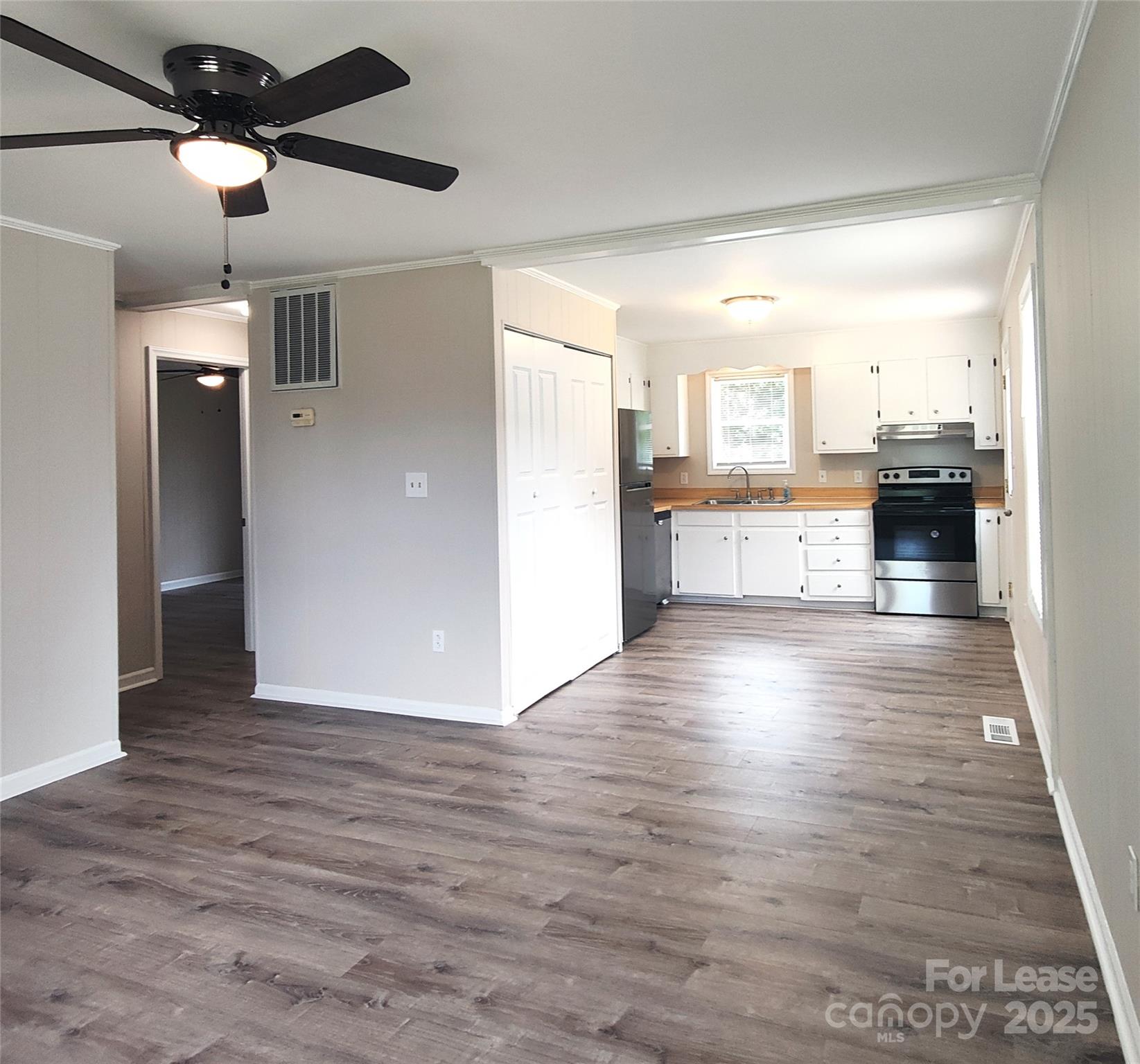 5325 Hemby Road, Unit B Weddington, NC 28104 - Photo 9 of 19 a view of a kitchen center island wooden floor and electronic appliances