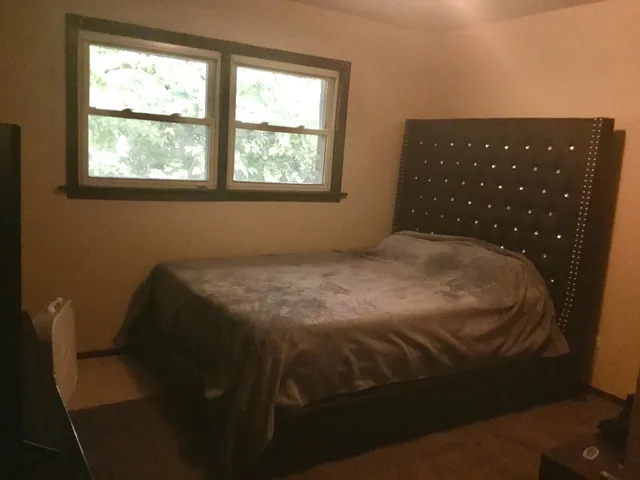 a bedroom with a bed and window