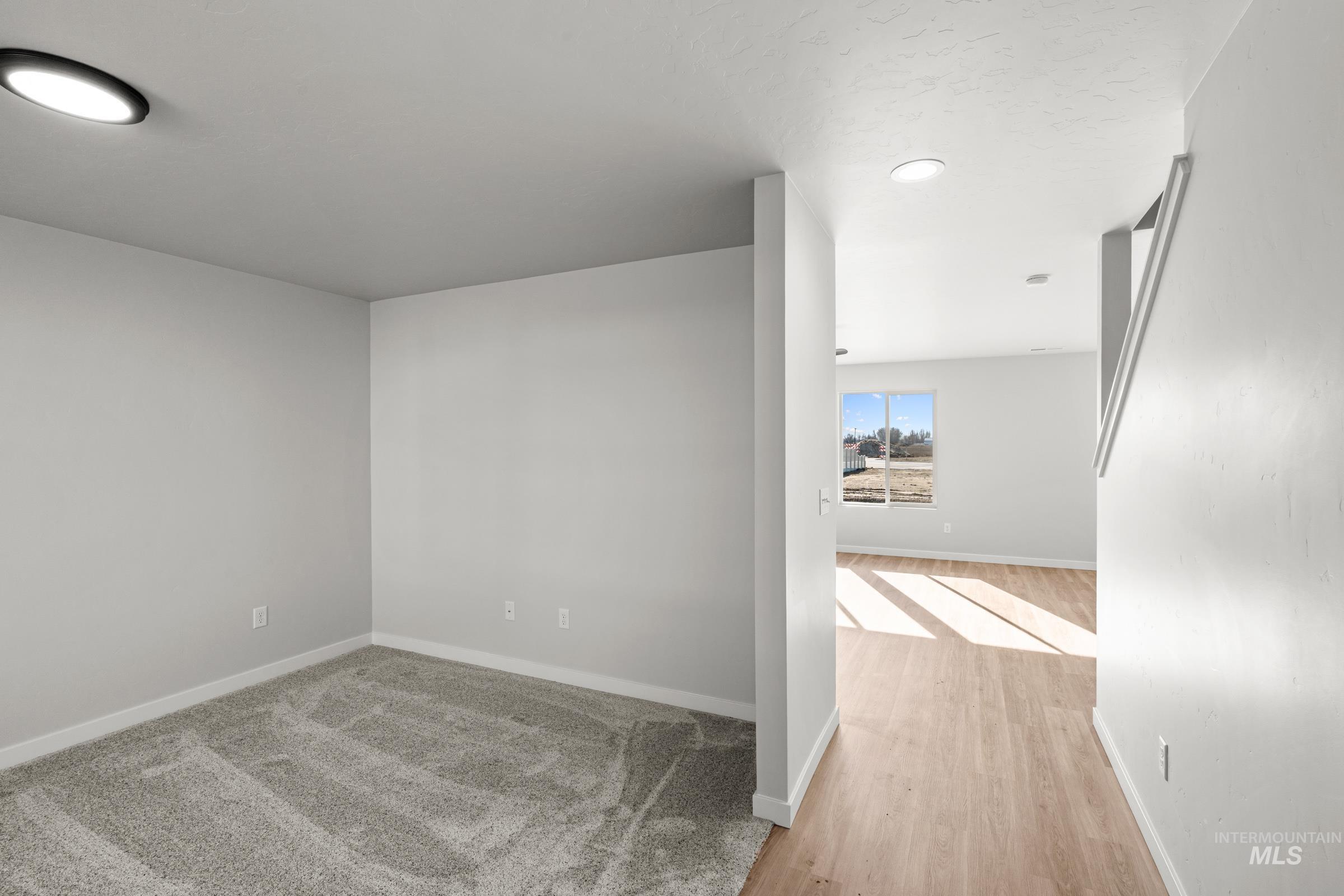 1687 Dyer Street Middleton, ID 83644 - Photo 13 of 28 Empty room featuring baseboards and light wood-type flooring