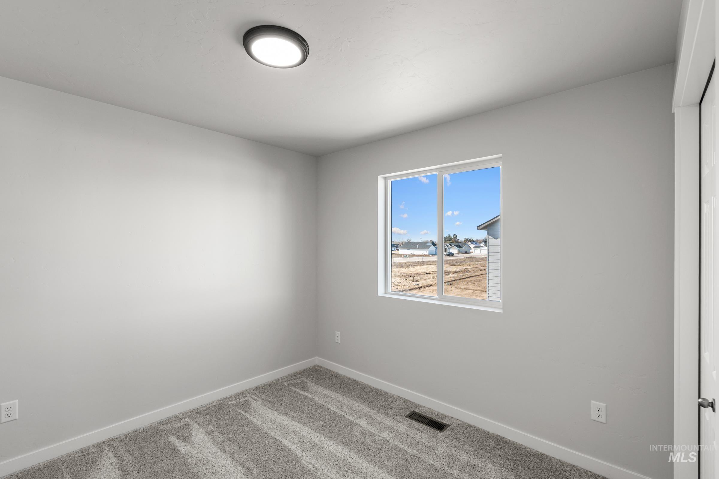 1687 Dyer Street Middleton, ID 83644 - Photo 21 of 28 Carpeted spare room with baseboards