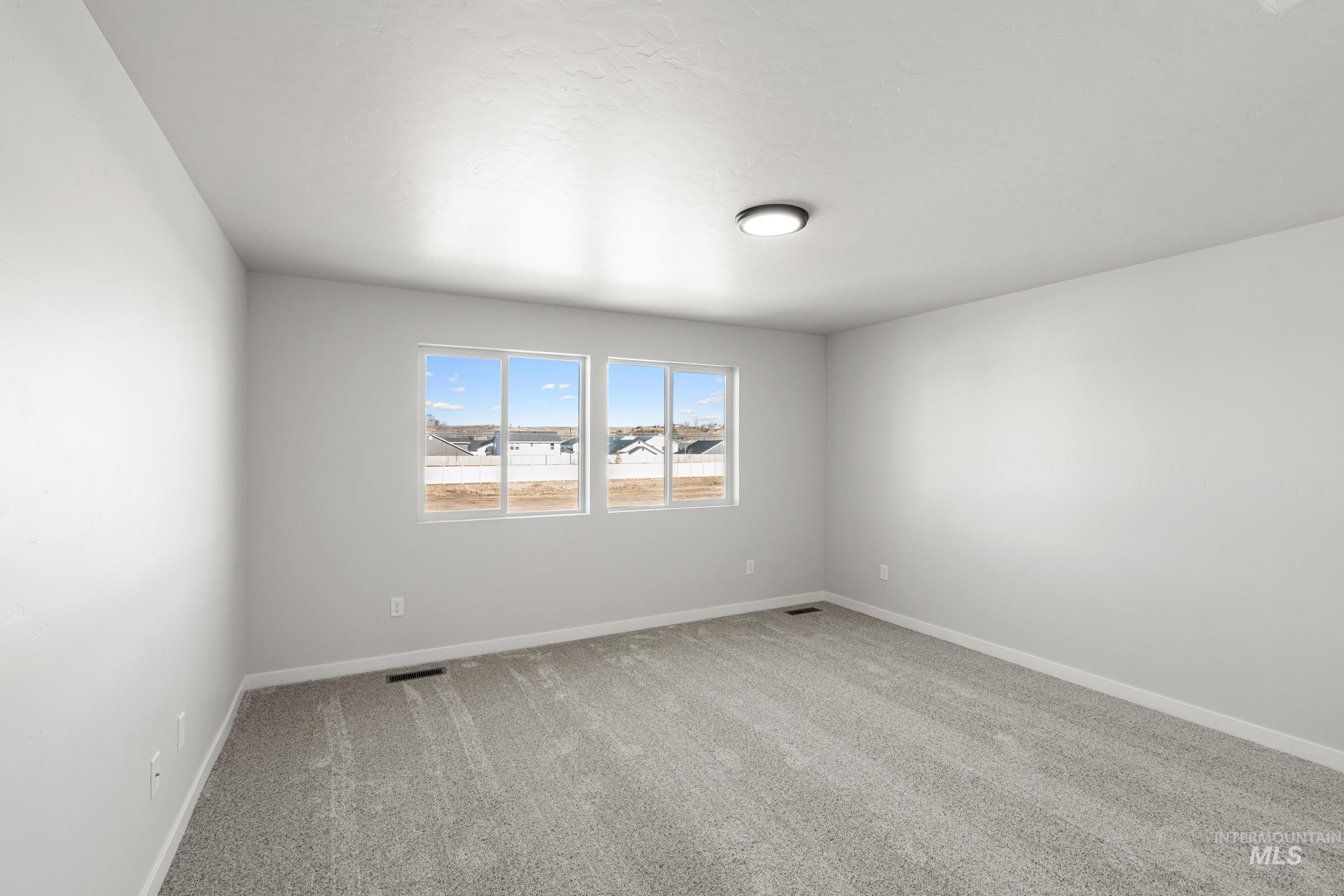1687 Dyer Street Middleton, ID 83644 - Photo 23 of 28 Spare room featuring light colored carpet and baseboards
