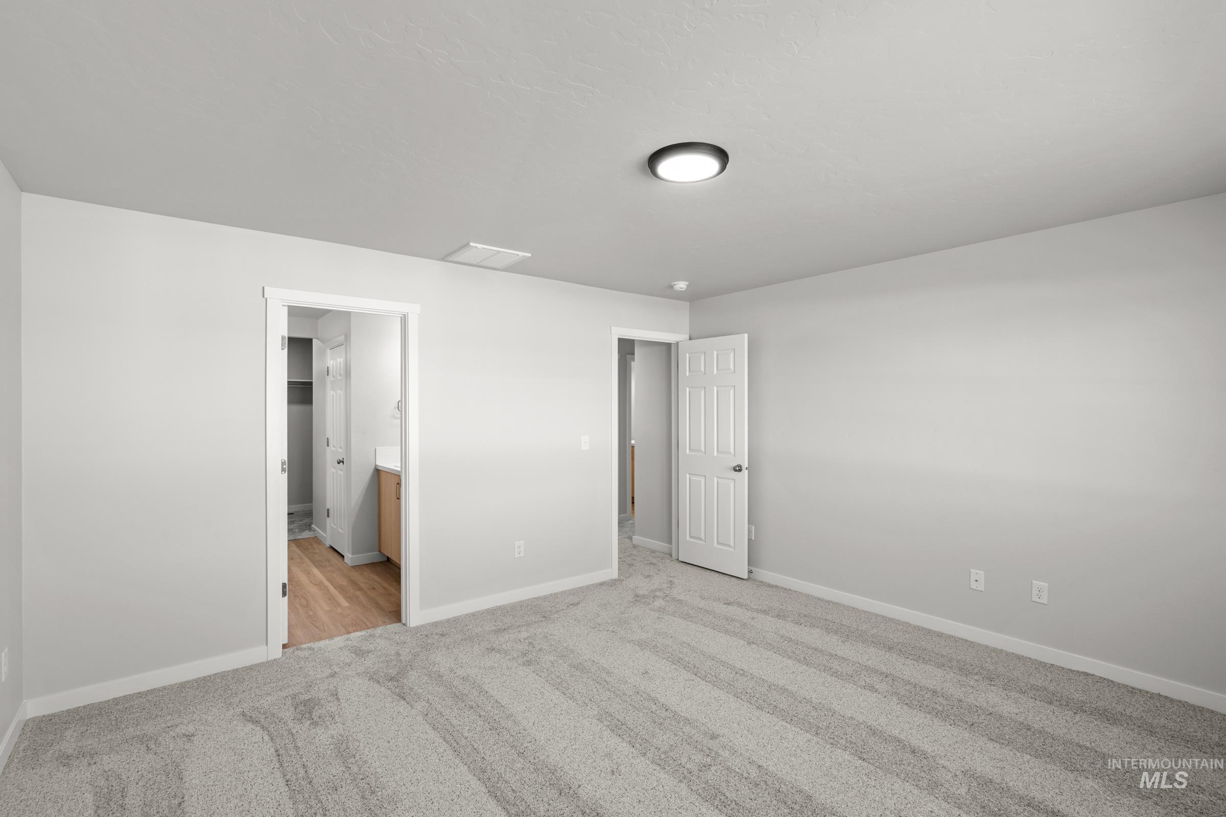 1687 Dyer Street Middleton, ID 83644 - Photo 24 of 28 Unfurnished bedroom with light colored carpet and ensuite bathroom
