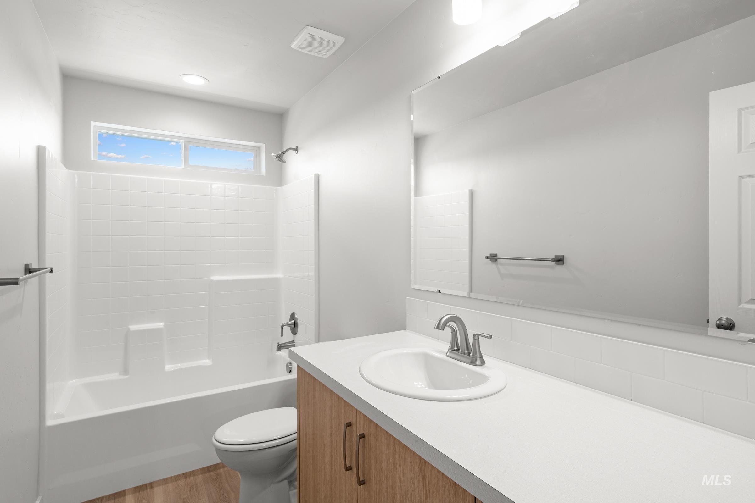 1687 Dyer Street Middleton, ID 83644 - Photo 28 of 28 Full bathroom with vanity, bathing tub / shower combination, and light wood-style floors