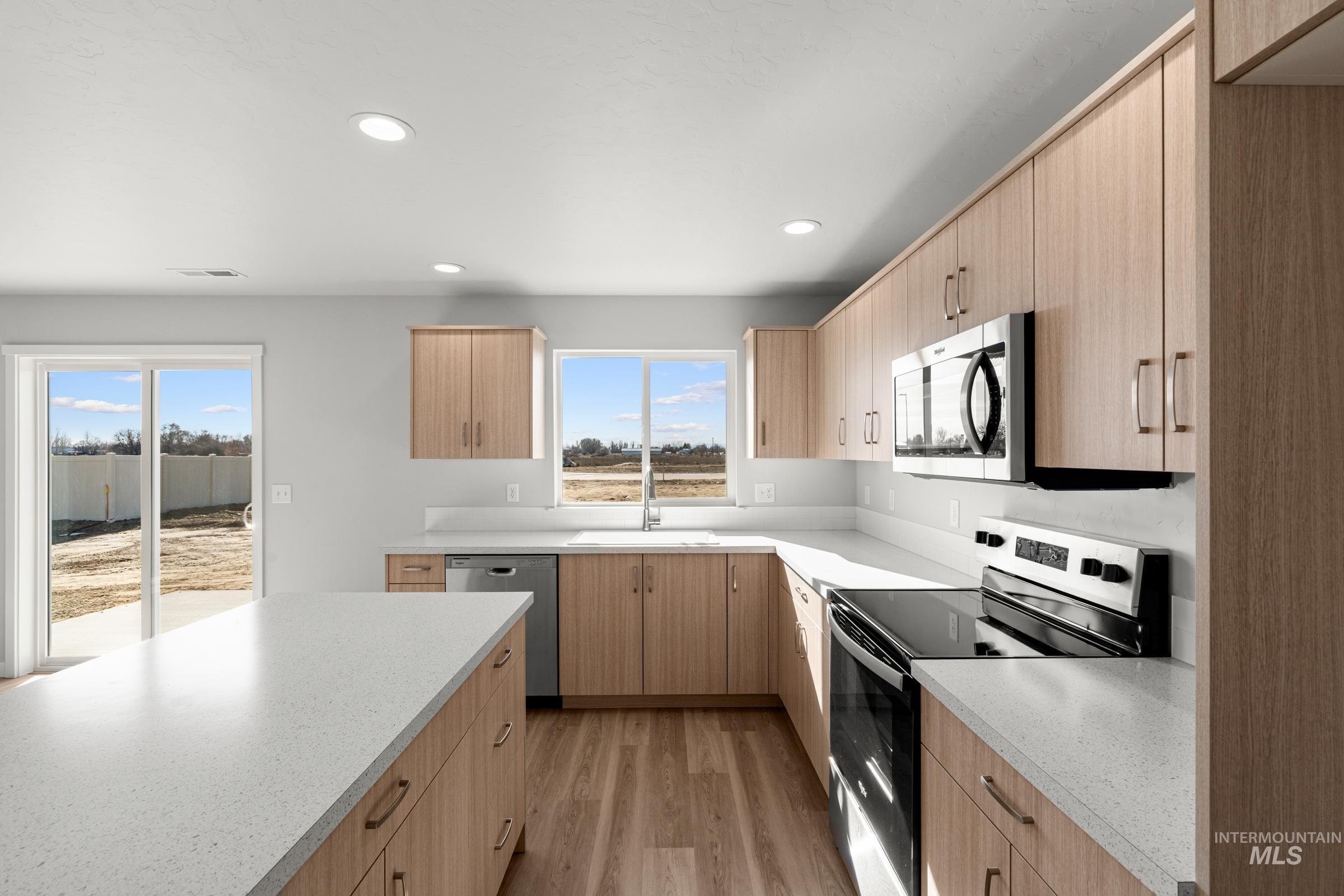 1687 Dyer Street Middleton, ID 83644 - Photo 5 of 28 Kitchen featuring stainless steel appliances, light wood finish cabinets, light wood-style flooring, recessed lighting, and modern cabinets