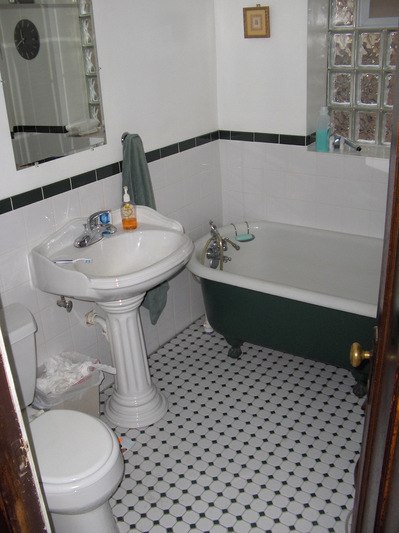 4039 North Long Avenue, Unit 1 Chicago, IL 60641 - Photo 2 of 20 a bathroom with a sink toilet and shower