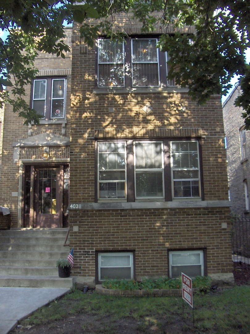 4039 North Long Avenue, Unit 1 Chicago, IL 60641 - Photo 8 of 20 a front view of a house with a yard