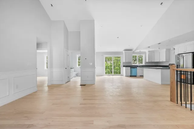 a view of a yard with plants and trees