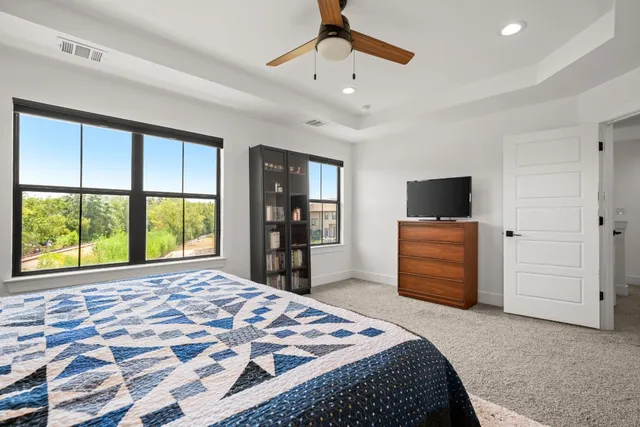 a bedroom with a bed and a television