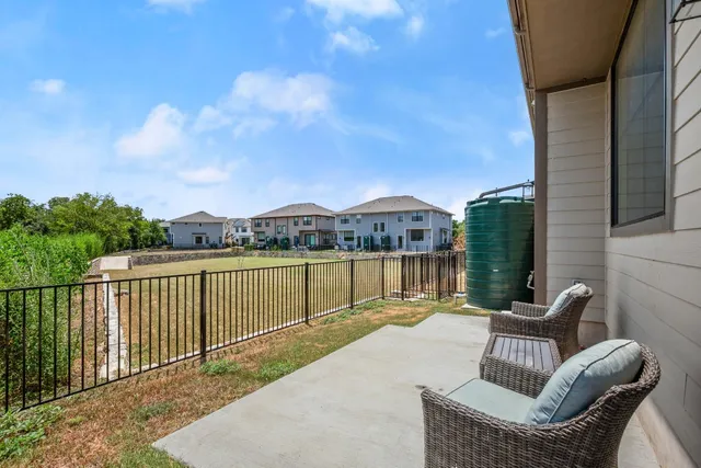 a view of house with outdoor seating space and lake view