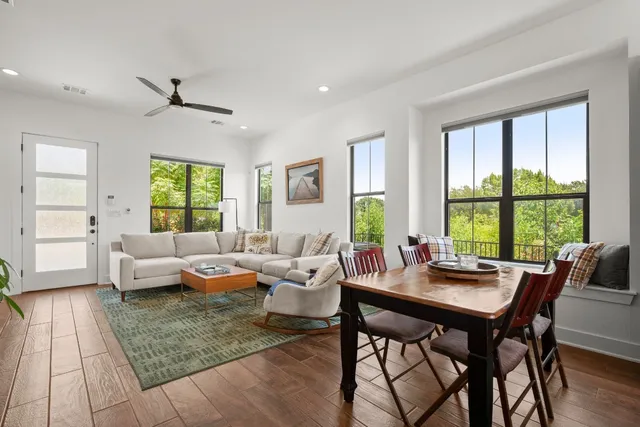 a living room with furniture and large windows