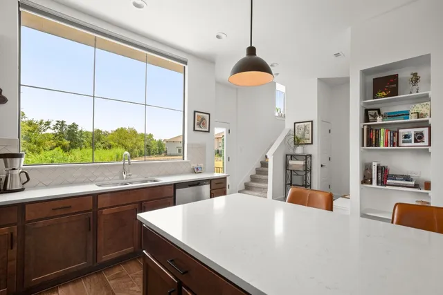 a large white kitchen with a large window