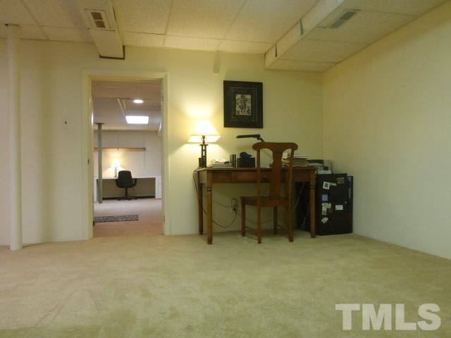 413 Quail Drive Raleigh, NC 27604 - Photo 14 of 24 The view looking back into the larger lower level space.