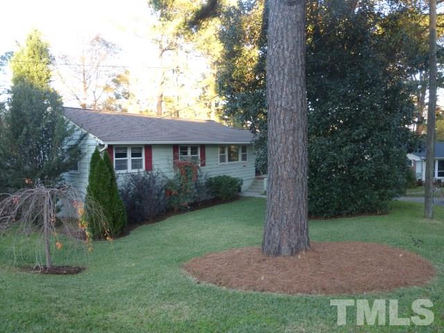413 Quail Drive Raleigh, NC 27604 - Photo 21 of 24 The front yard includes a large Rhododendron tree.