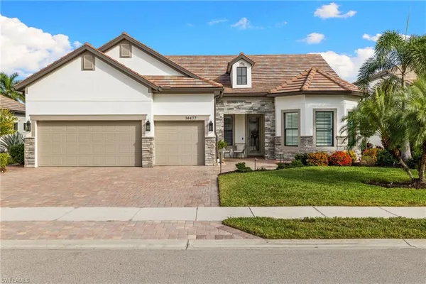 a front view of a house with a yard and garage