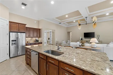 a kitchen with stainless steel appliances granite countertop a sink dishwasher stove and refrigerator