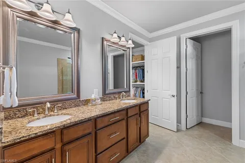a spacious bathroom with double sink and a mirror
